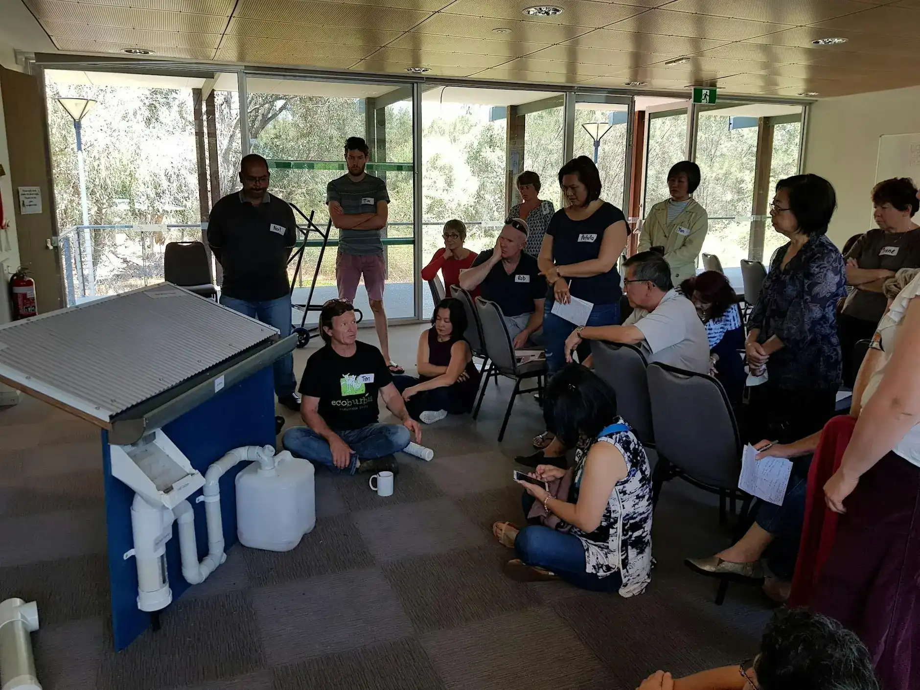 Group of people listening to person talking.